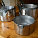 Set of five hammered aluminum saucepans
